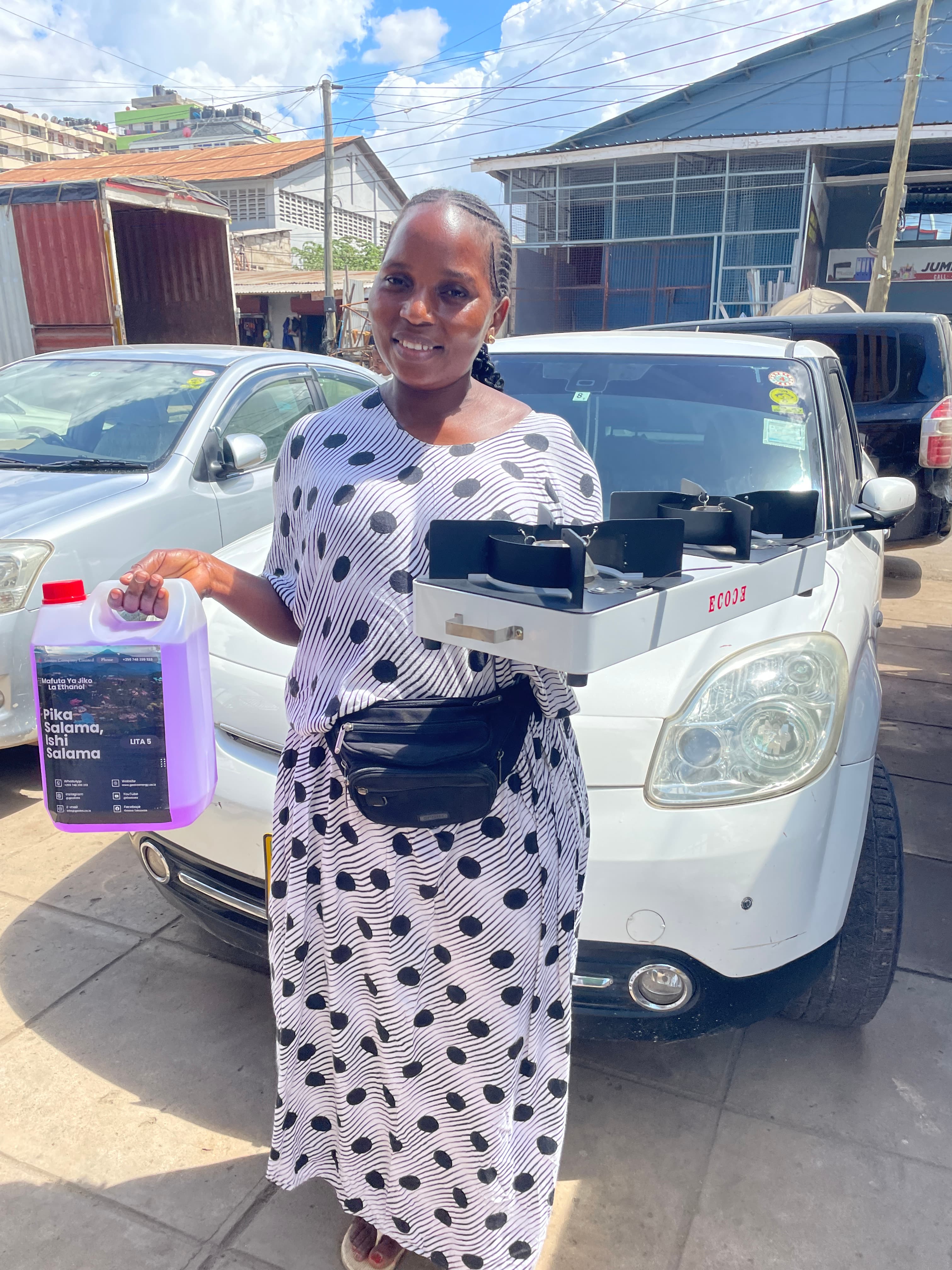 A Gastro customer holding a bottle of ethanol cooking fuel and a portable ethanol stove
