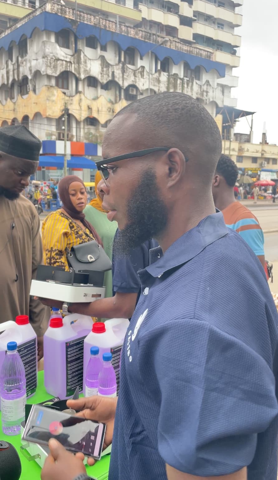 A Gastro team member with ethanol fuel containers during a community engagement in Tanzania
