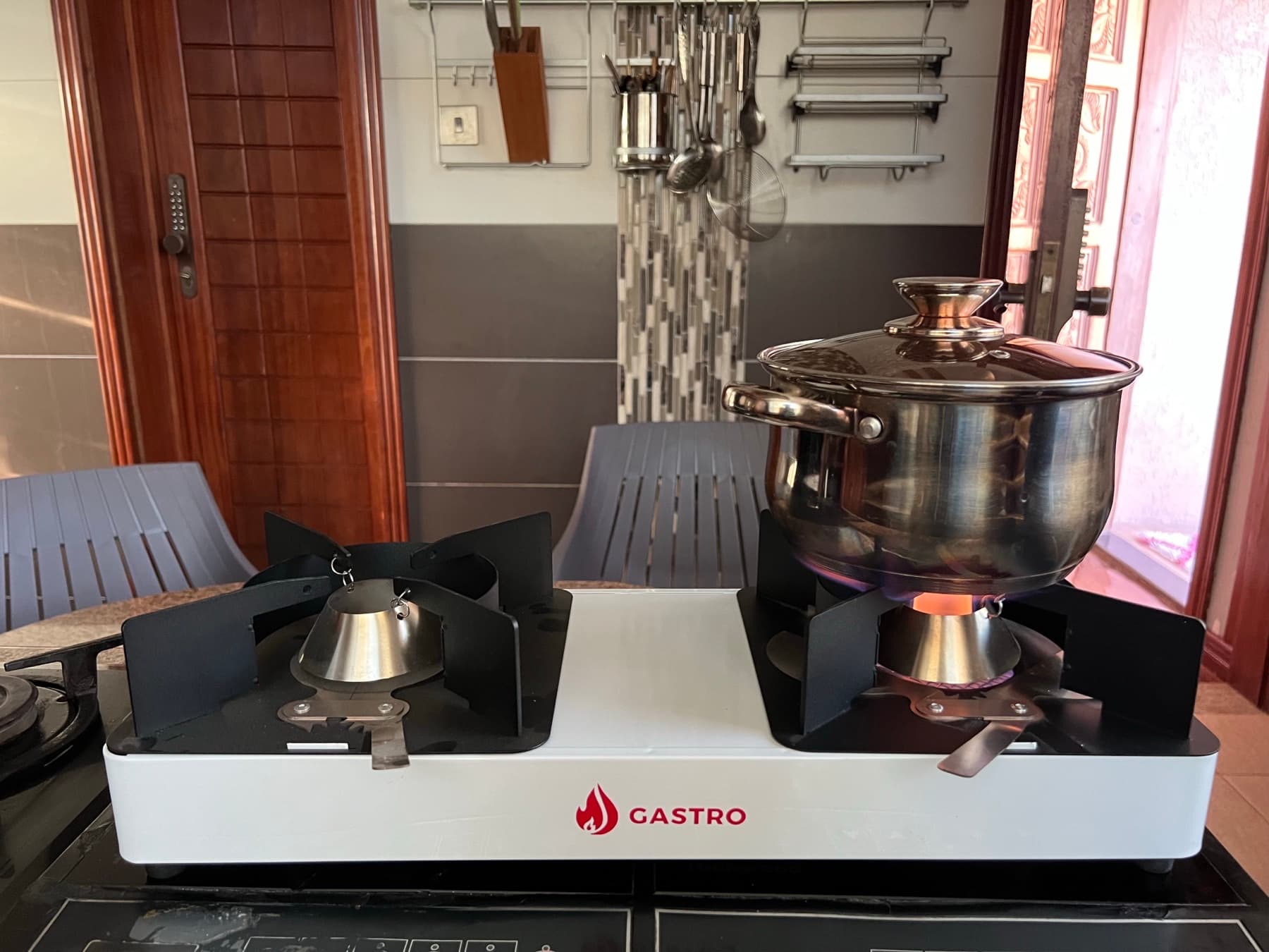 The improved Gastro double-burner ethanol cookstove with a pot on the lit burner